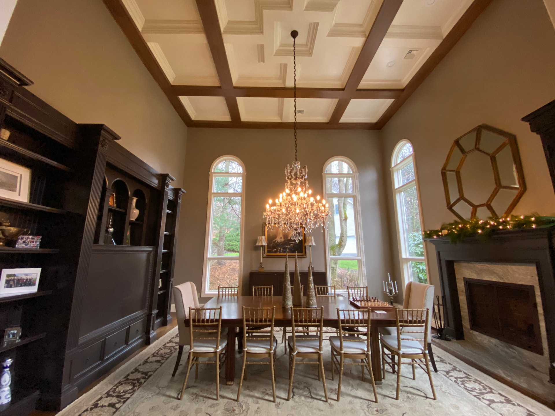 Finished dining room with coffered ceiling, dark built-in cabinetry, and painted walls