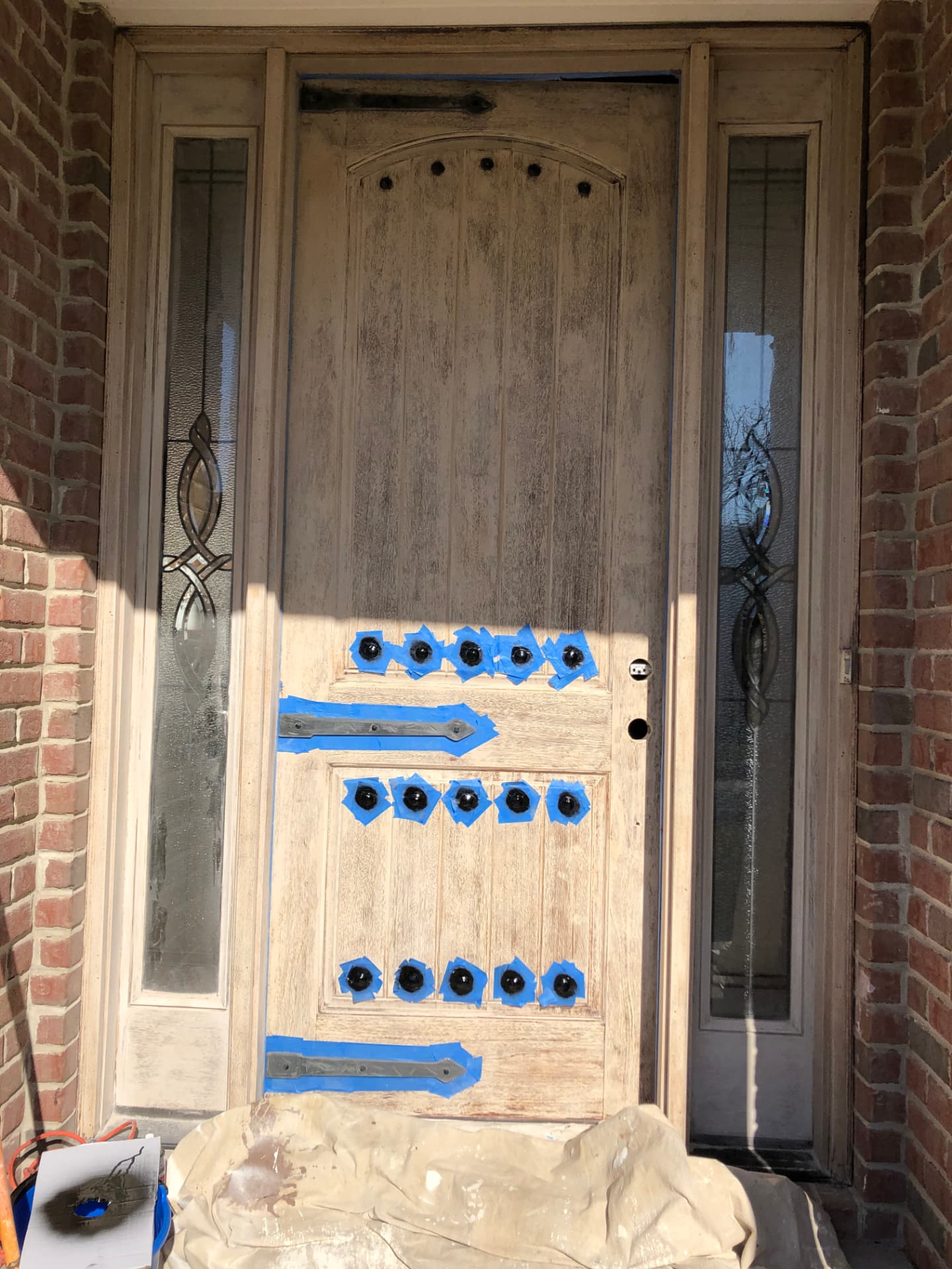 Front door and sidelights prepared for a new finish