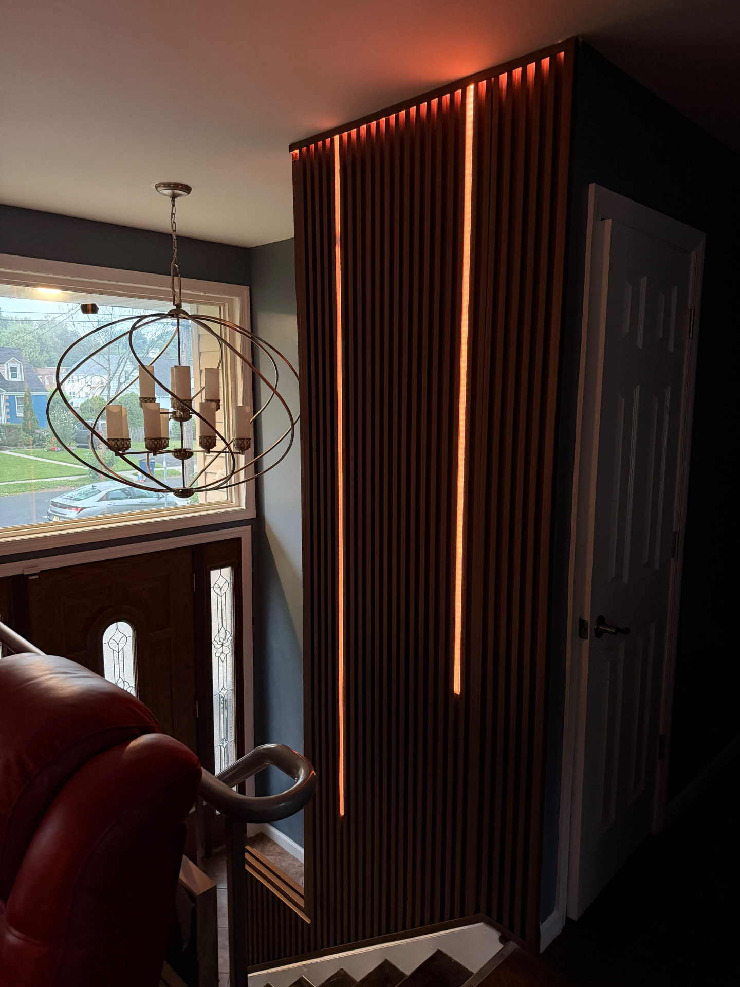 Illuminated wood accent wall beside the staircase