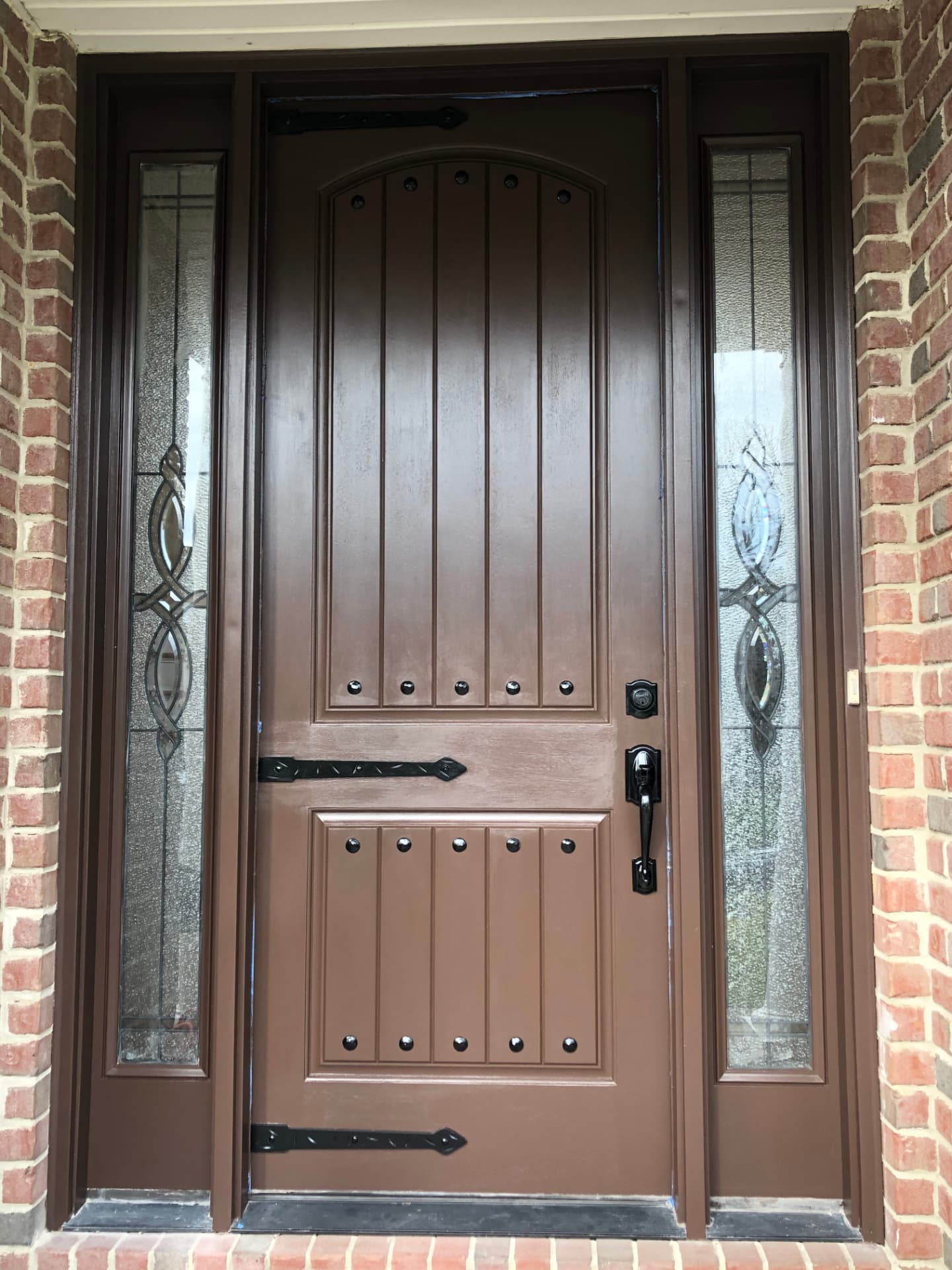 Front door and sidelights with a finished brown coating