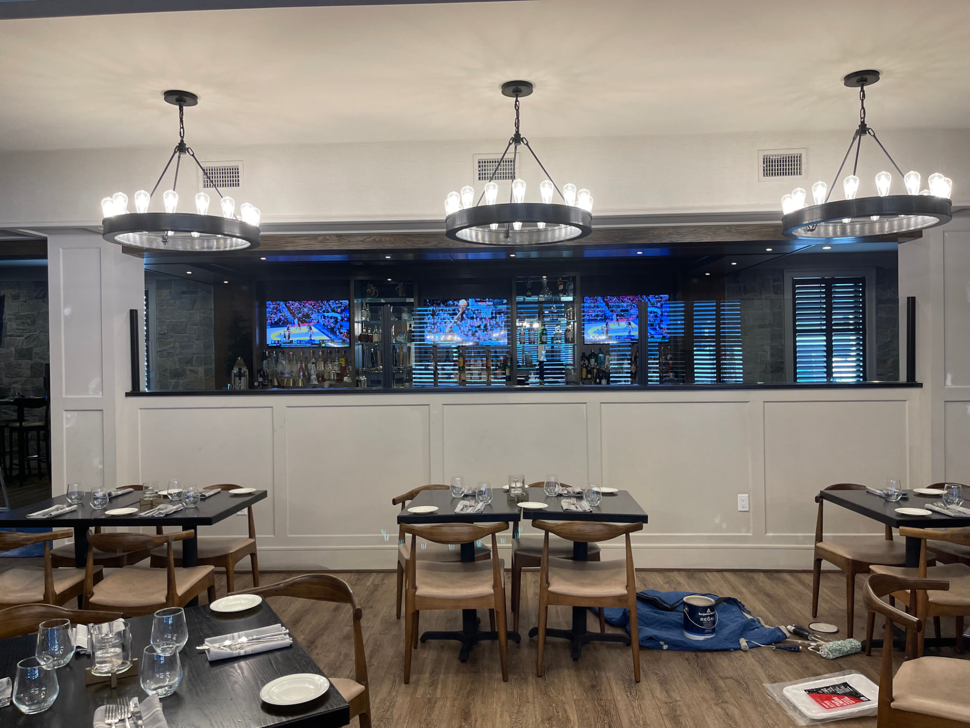 Restaurant dining room with painted wall paneling and bar surround