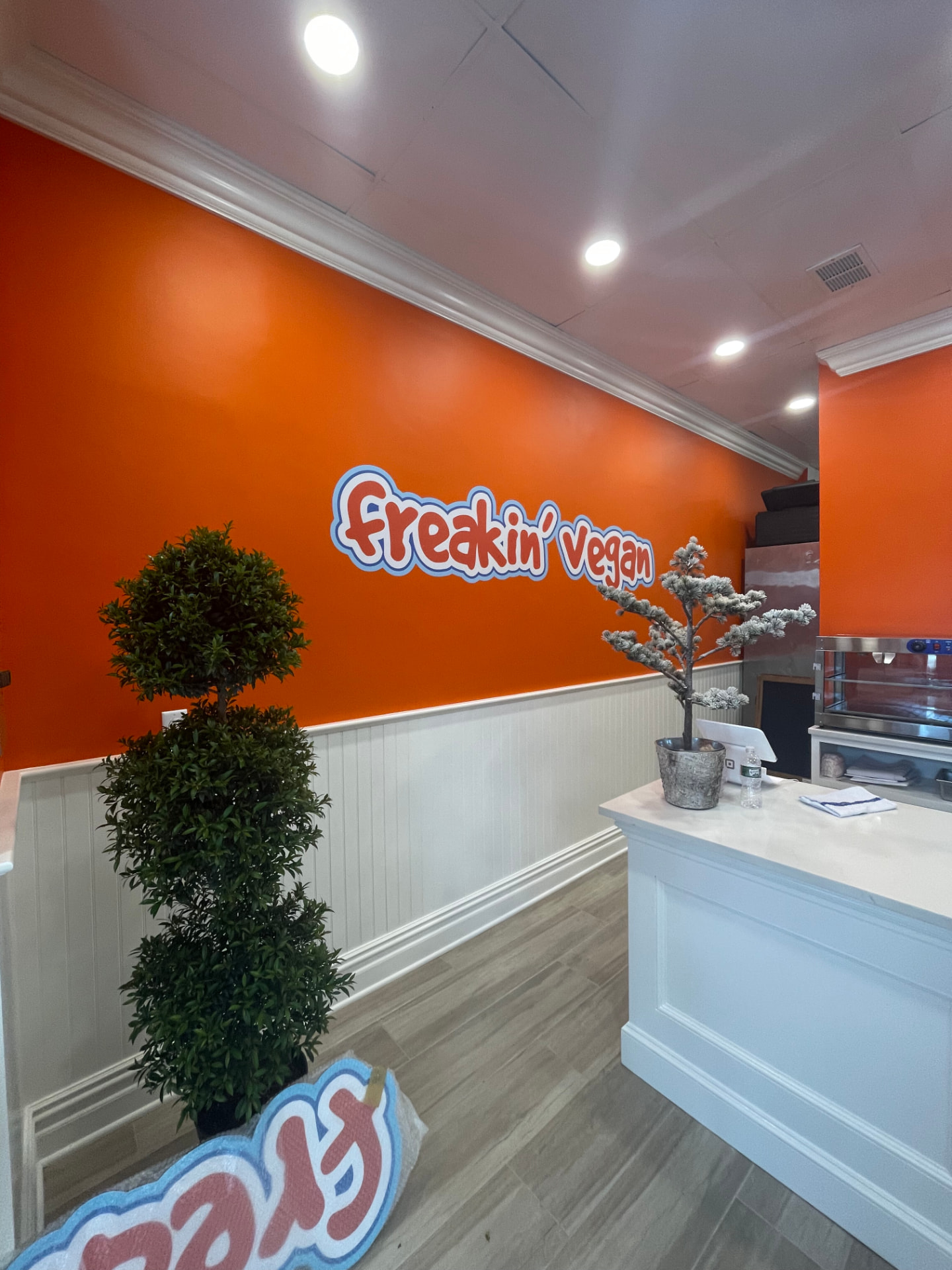 Restaurant orange accent wall with white wainscoting and crown molding