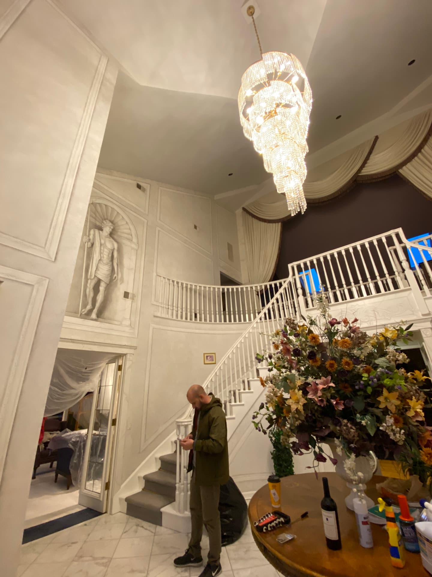Grand entryway with painted wall panels and white stair balusters